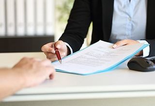 Contractors Insurance — Man Signing Contract in Mystic, CT Contractors Insurance — Man Signing Contract in Mystic, CT