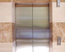 For all lift services throughout Central Scotland, call Scotec Lifts Ltd on 0141 646 0900 empty contemporary interior with elevator steel doors