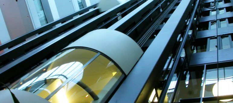 For lift options and lift services in Scotland, call Scotec Lifts Ltd now on 0141 646 0900 Image of elevator going up in commercial building