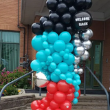 A bunch of balloons with one that says welcome back on it