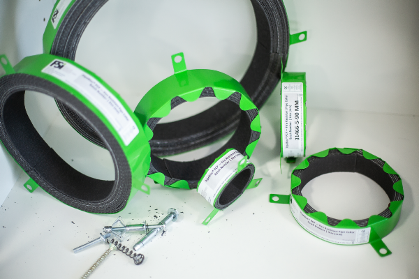 A number of green plastic gaskets and seals that have had parts identification labels stuck to them