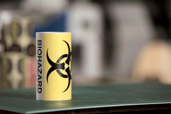 Reel of printed labels laid on its side showing the Biohazard warning pictogram