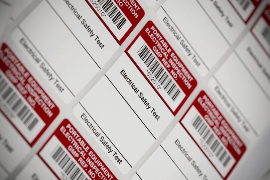 Sheets of Electrical Safety Test / PAT Test labels with barcodes on