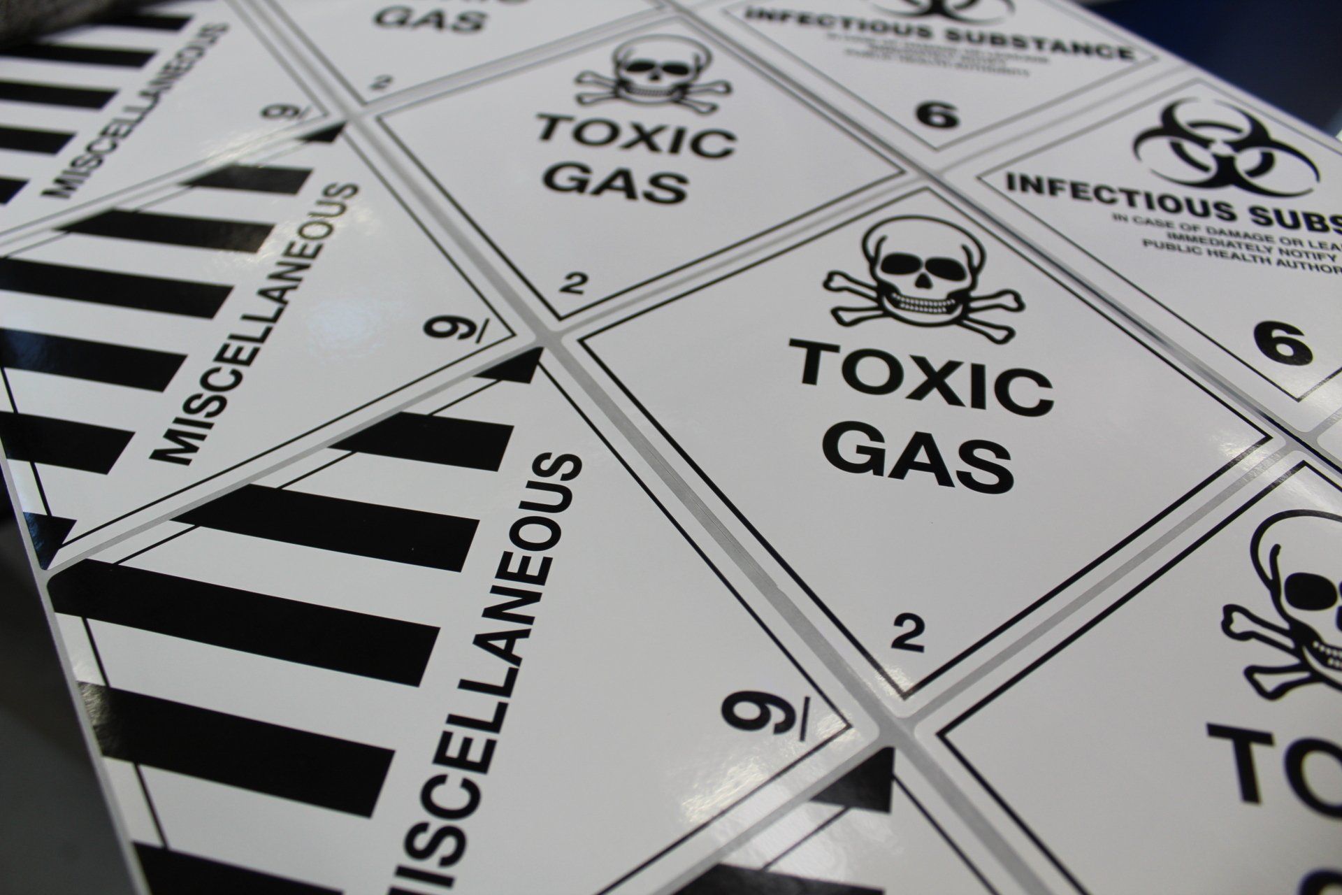 Web of three different hazard warning pictogram labels all being printed at the same time