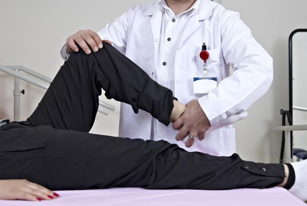 Physiotherapist giving knee therapy to the patient