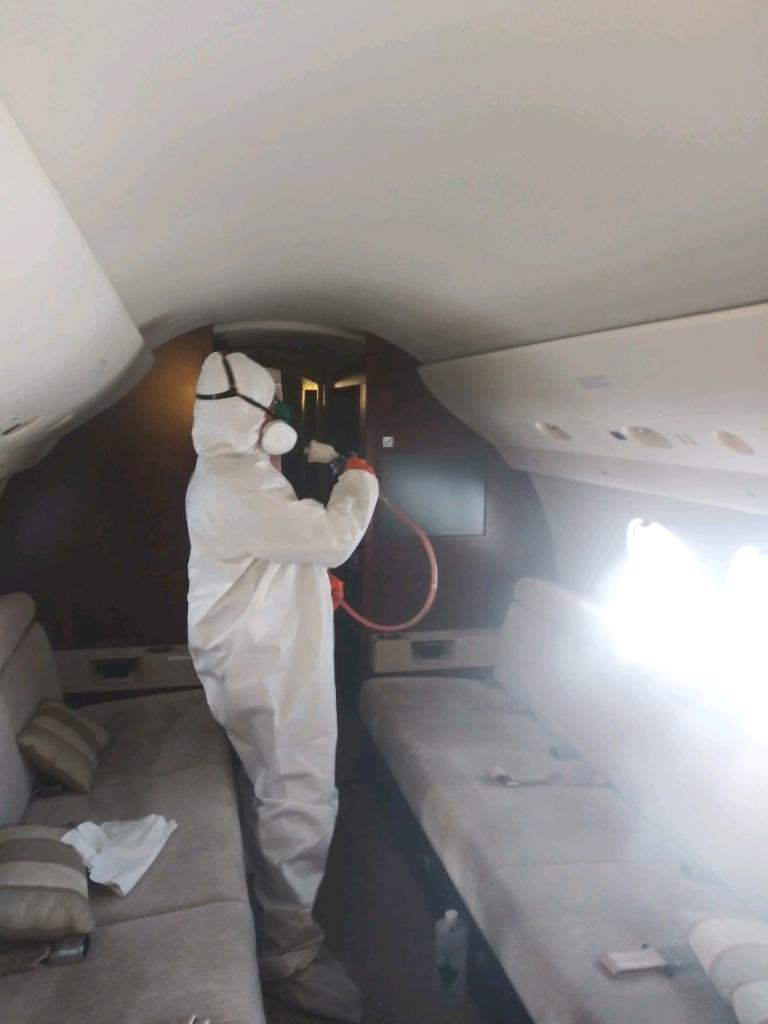 man cleaning plane interior