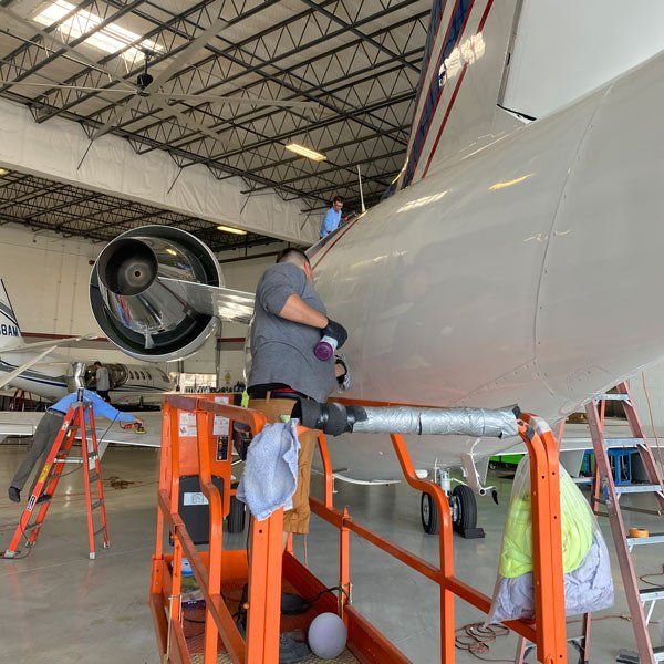 man cleaning airplane