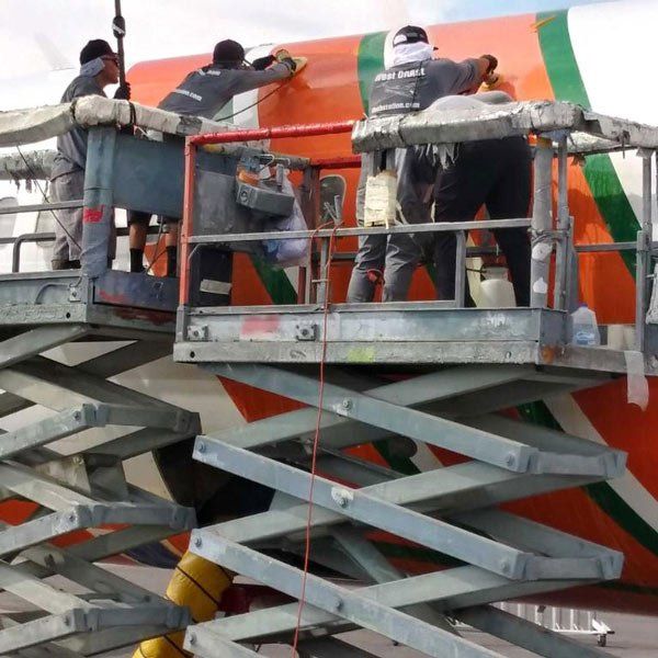 scissor lifts with men cleaning plane