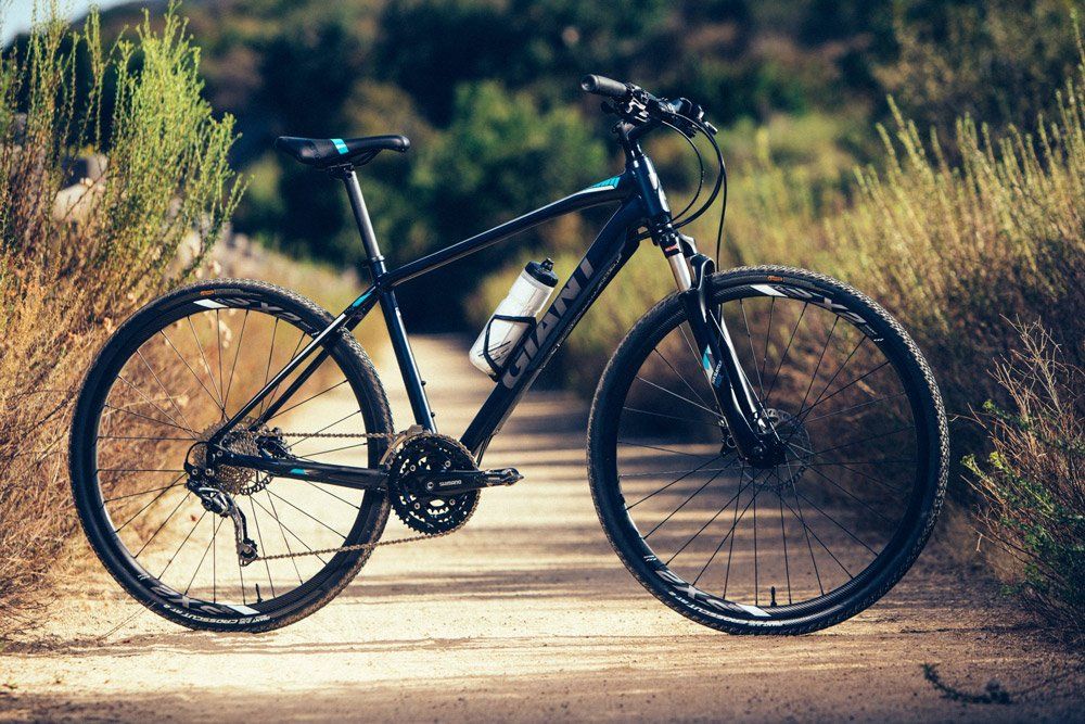 Giant Black Hybrid Bike with a Tumbler