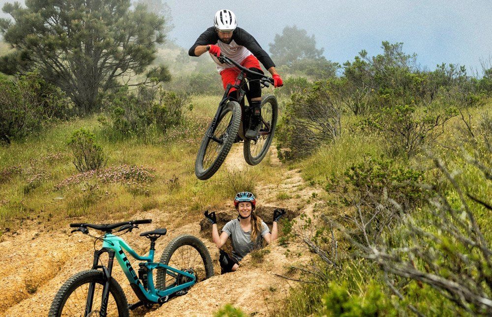 Man doing bicycle tricks using Trek Mountain Bike