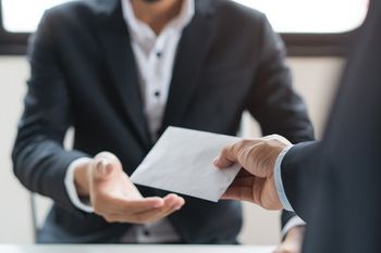 person handing over check