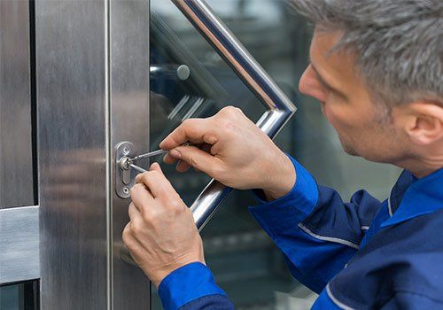 Installation — A Man Installing A Door Lock in Boston, MA Installation — A Man Installing A Door Lock in Boston, MA