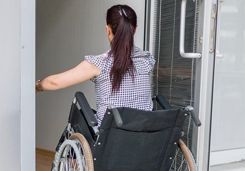 Handicap Doors — A PWD Woman Entering A Door in Boston, MA Handicap Doors — A PWD Woman Entering A Door in Boston, MA