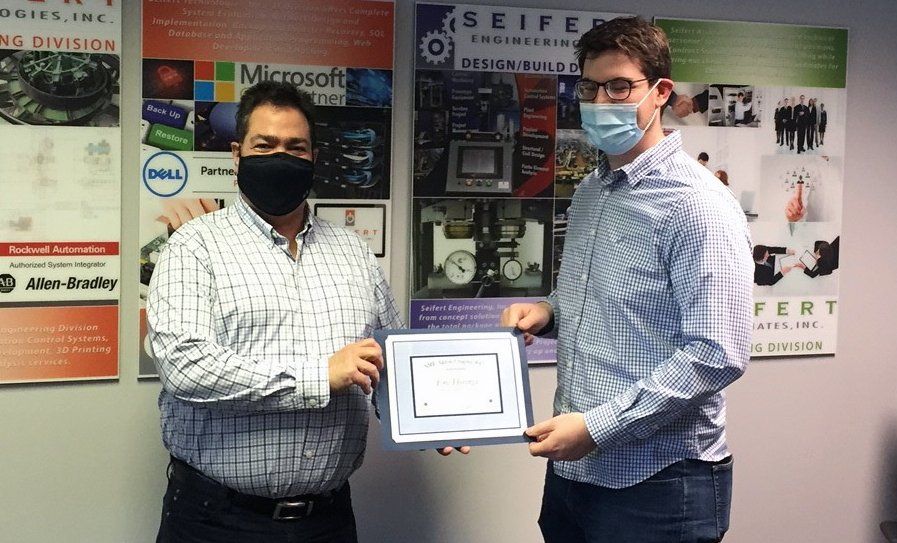 Tim Seifert presenting a certificate to a recipient