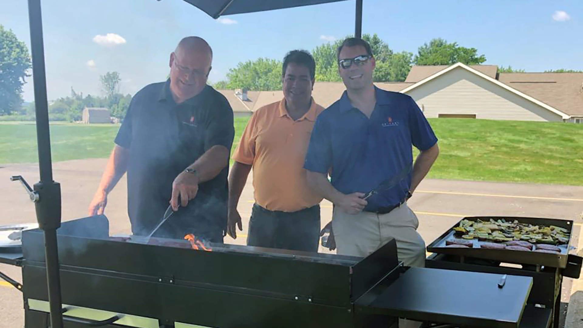 Three employees at the grill
