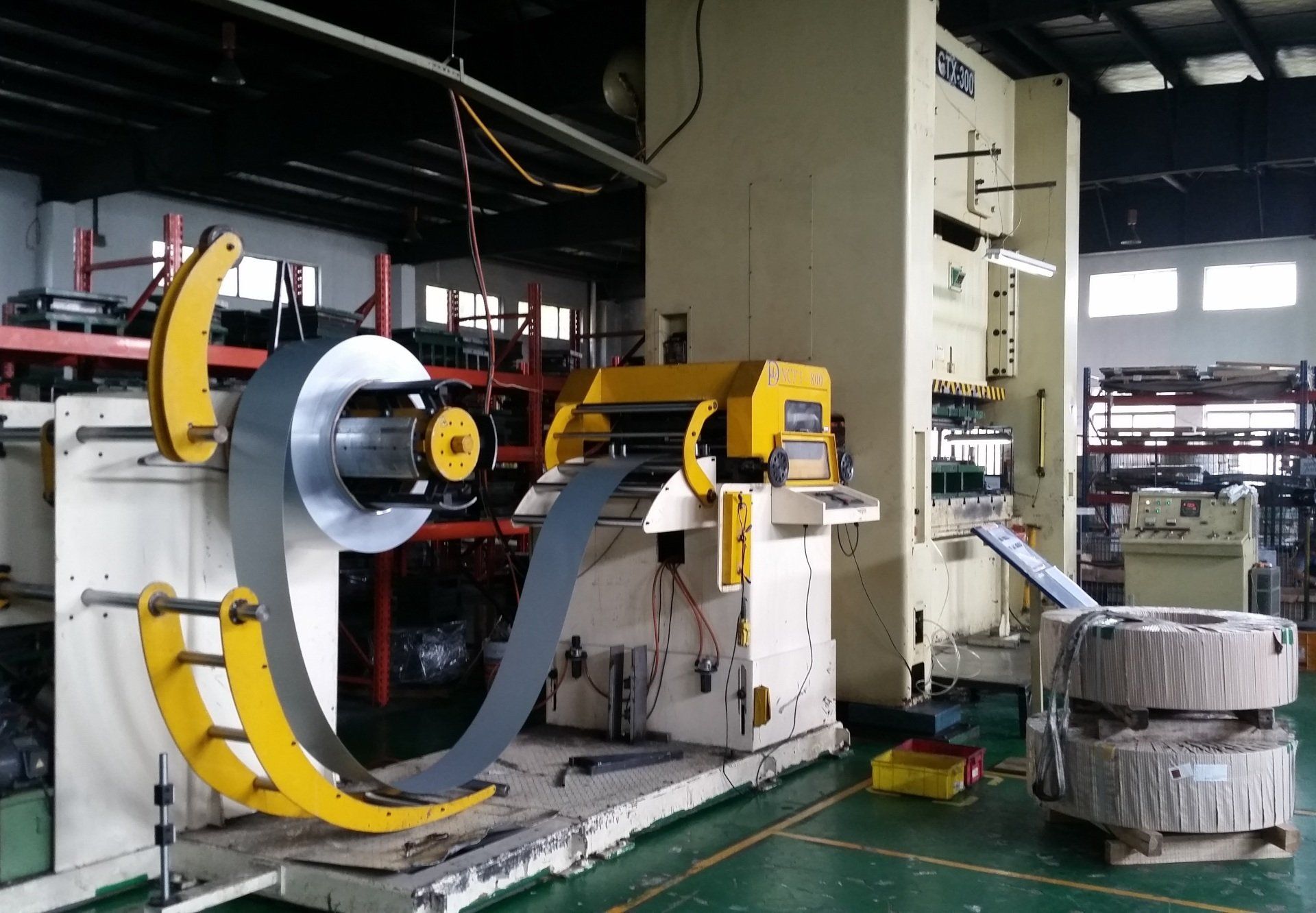 A stamping press and a steel coil.
