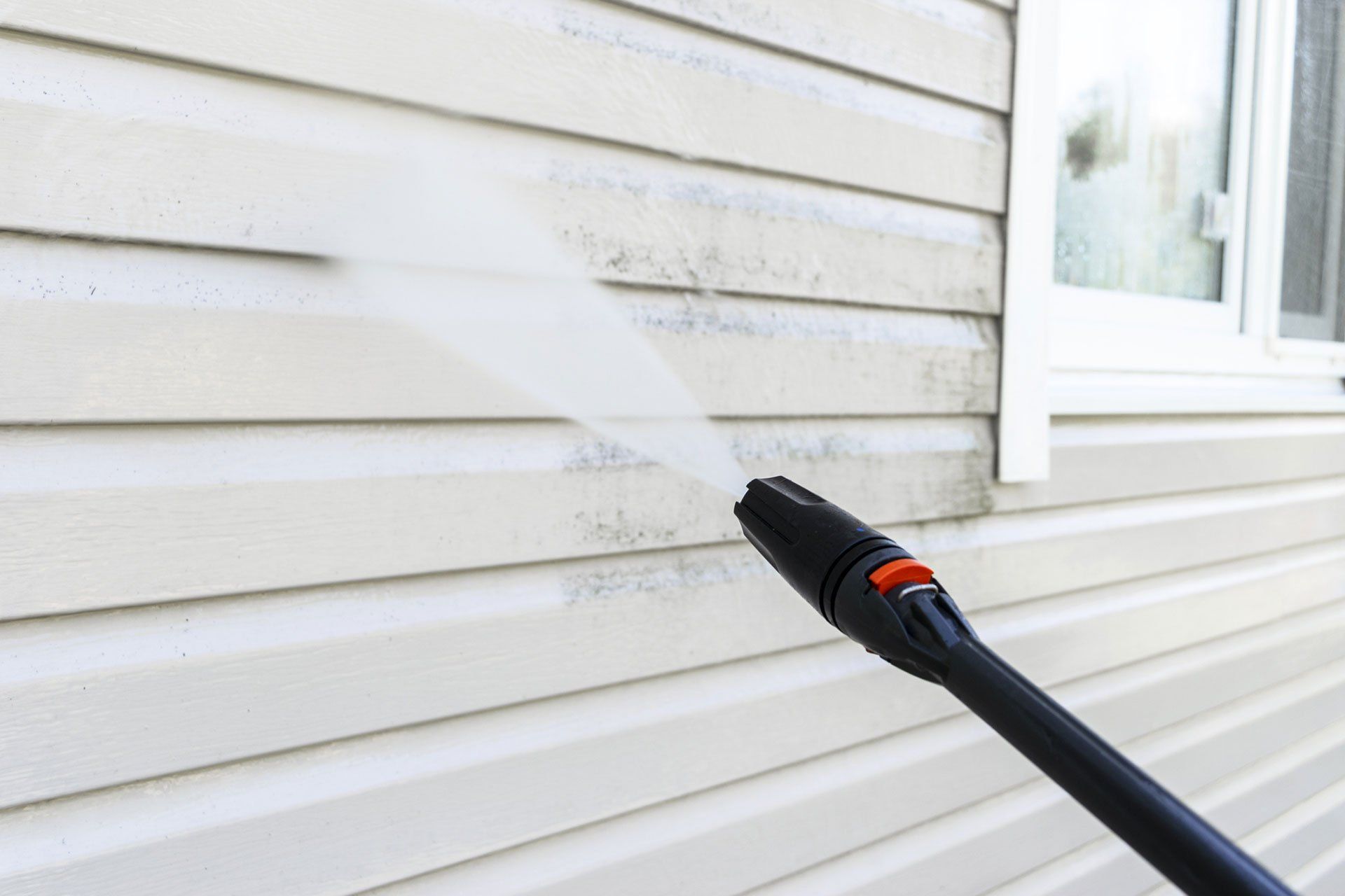 washing building facade with pressure water