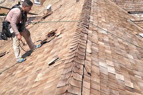 Roof repair worker with security rope