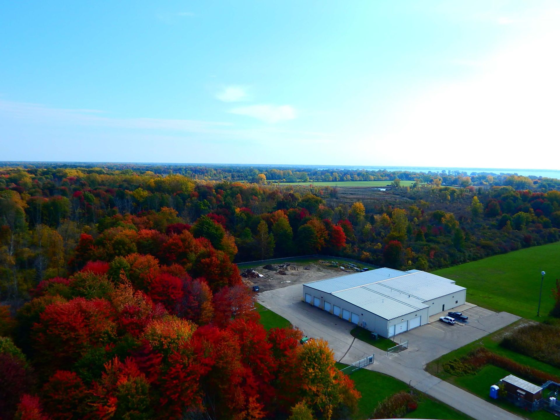 An aerial view of a building in the middle of a forest.