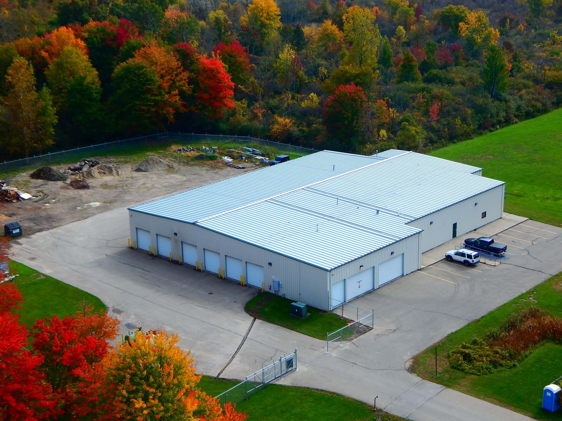 An aerial view of a large building with a white roof.