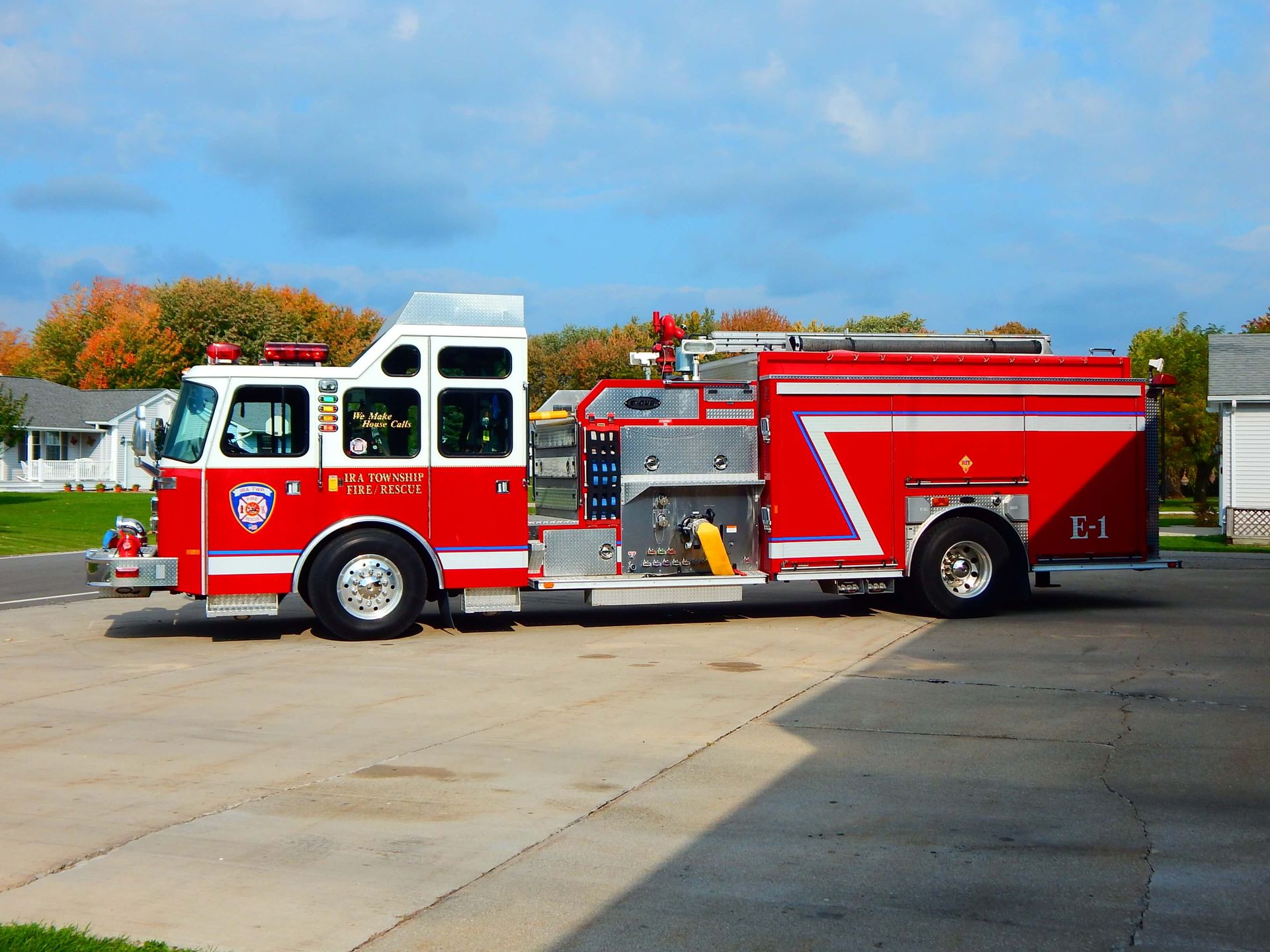 A red fire truck is parked in front of a building that says Ira Township Fire Department.