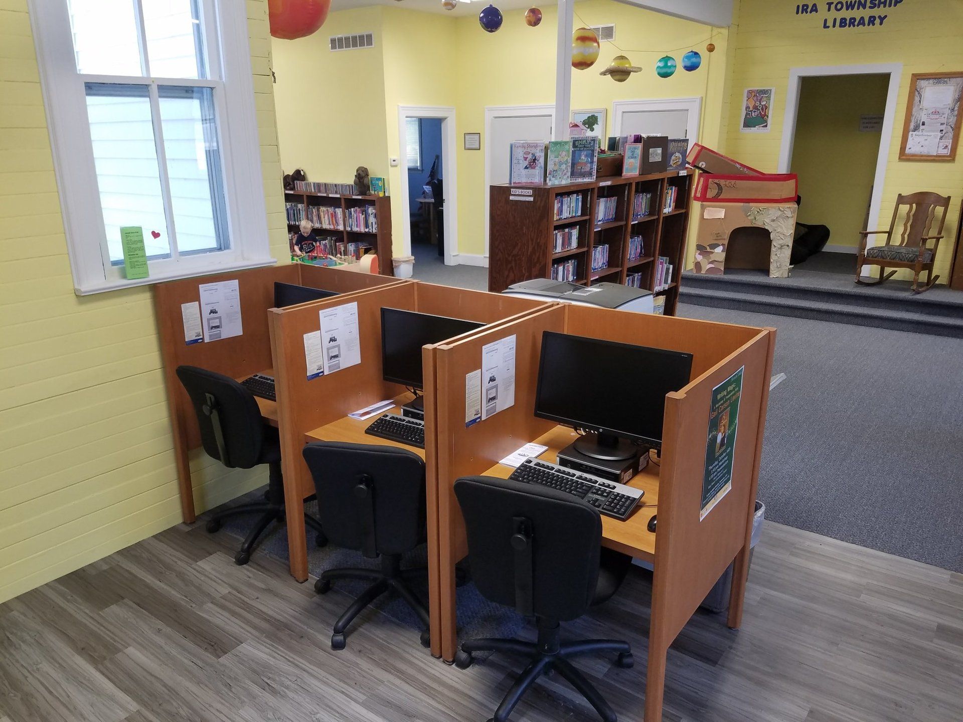 A library with some computers at desks.