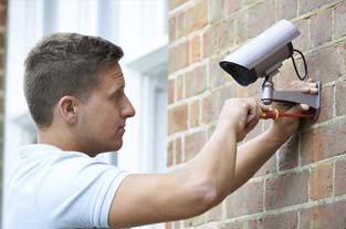 Man Installing a Camera |Superior Alarm Systems|Upper Darby, PA Man Installing a Camera |Superior Alarm Systems|Upper Darby, PA