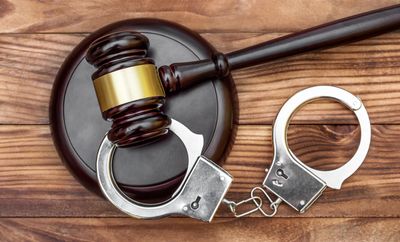 Criminal Defense Attorney — Gavel With Stand and Handcuffs in Court in Johnston, RI Criminal Defense Attorney — Gavel With Stand and Handcuffs in Court in Johnston, RI