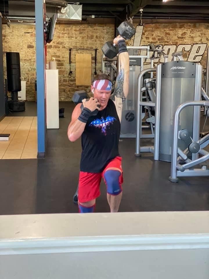 Man Holding Dumbbells — Breckenridge, TX — One More Fitness