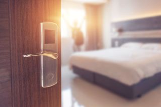 Family Hotel — Open Door and Bed in Miami, FL
