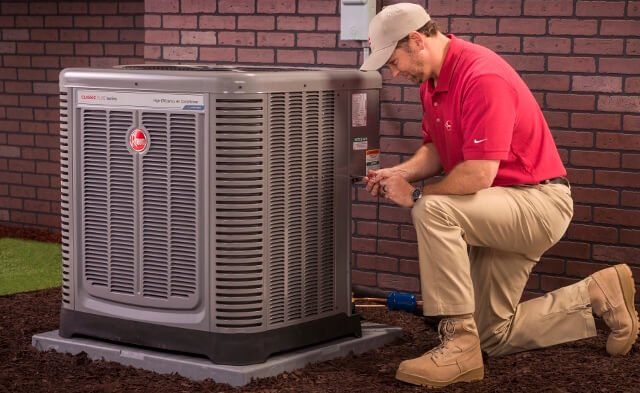 We partner with Rheem to bring you quality units HVAC Maintenance man installing rheem unit at a local home in Arkansas
