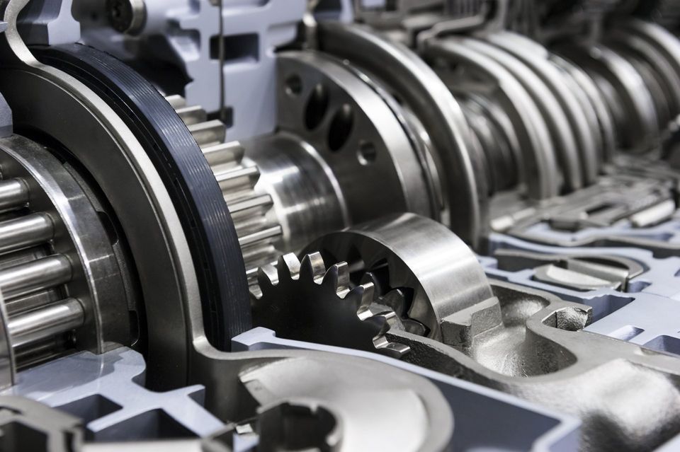 Close-up of shiny metal gears and mechanical parts in an industrial machine assembly