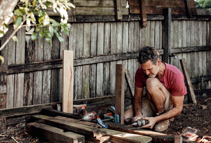 man fixing fence