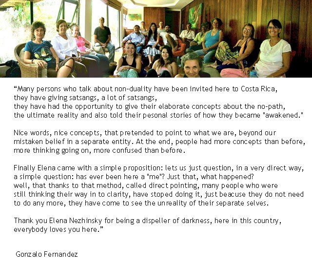 Group of people sitting and standing indoors; text about non-duality and self-realization.