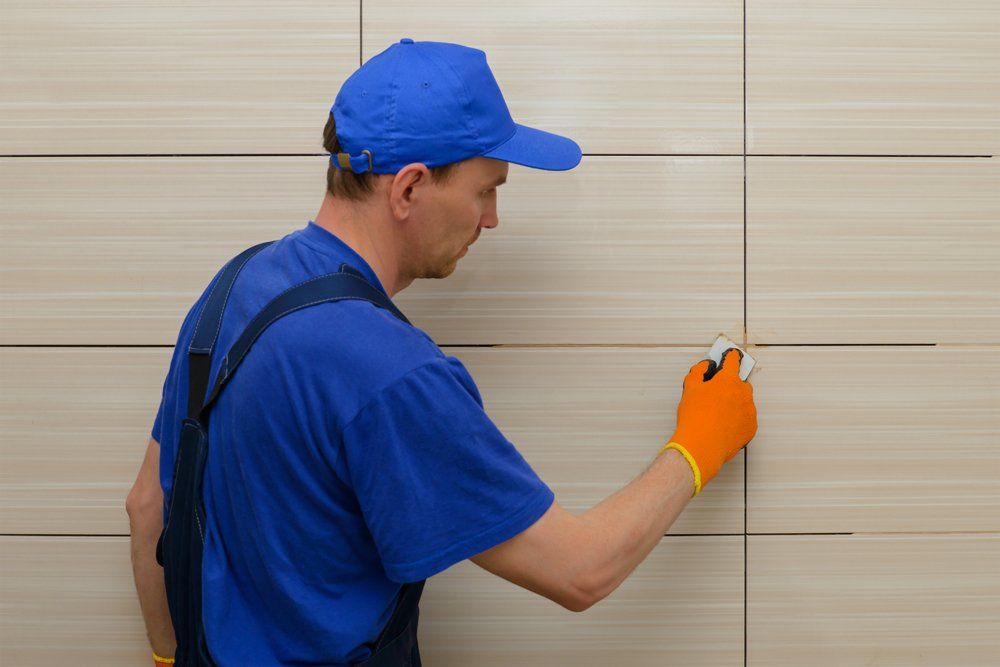Grout Cleaning — Man Cleaning Grout in Ipswich, MA Grout Cleaning — Man Cleaning Grout in Ipswich, MA