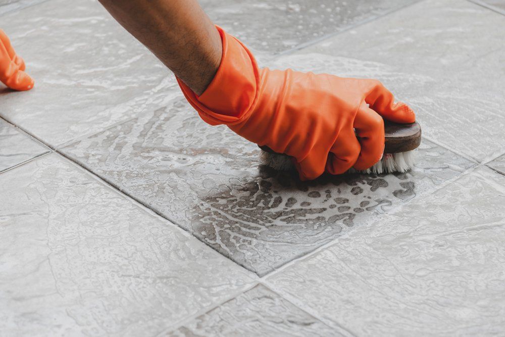 Tile Cleaning — Hand of Man Cleaning Tile Floor in Ipswich, MA Tile Cleaning — Hand of Man Cleaning Tile Floor in Ipswich, MA