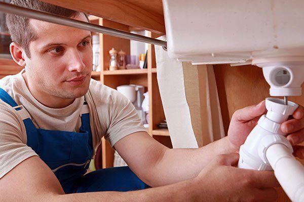 Plumber fixing sink A contractor finishing plumbing repair service in Somerset, KY