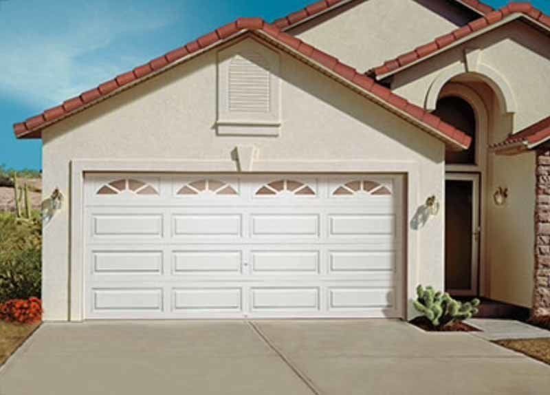 residential home and garage door with long panel design and windows