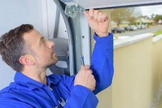 man repairing garage door