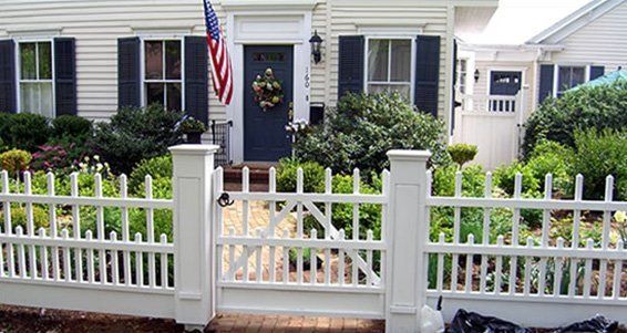 house with flag and white fence