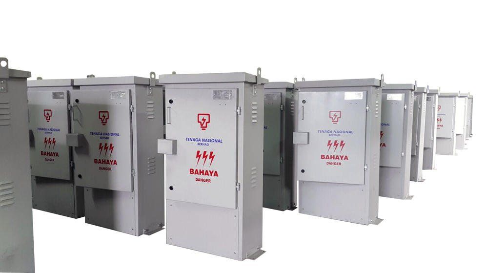 Row of gray electrical boxes with red symbols and text.