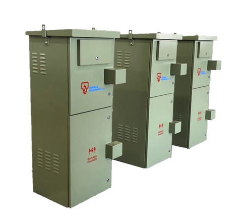 Three stacked, gray electrical boxes with doors and vents, likely transformers, outdoors.