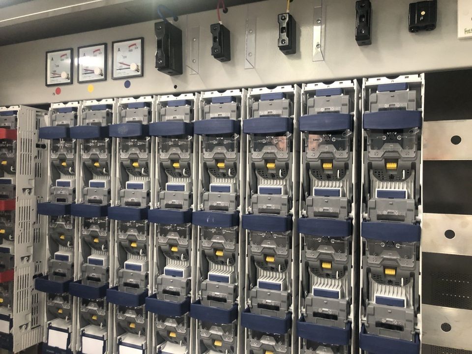 A wall of communication equipment with numerous vertical panels.