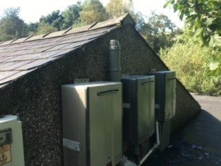 a row of electrical boxes on the side of a building