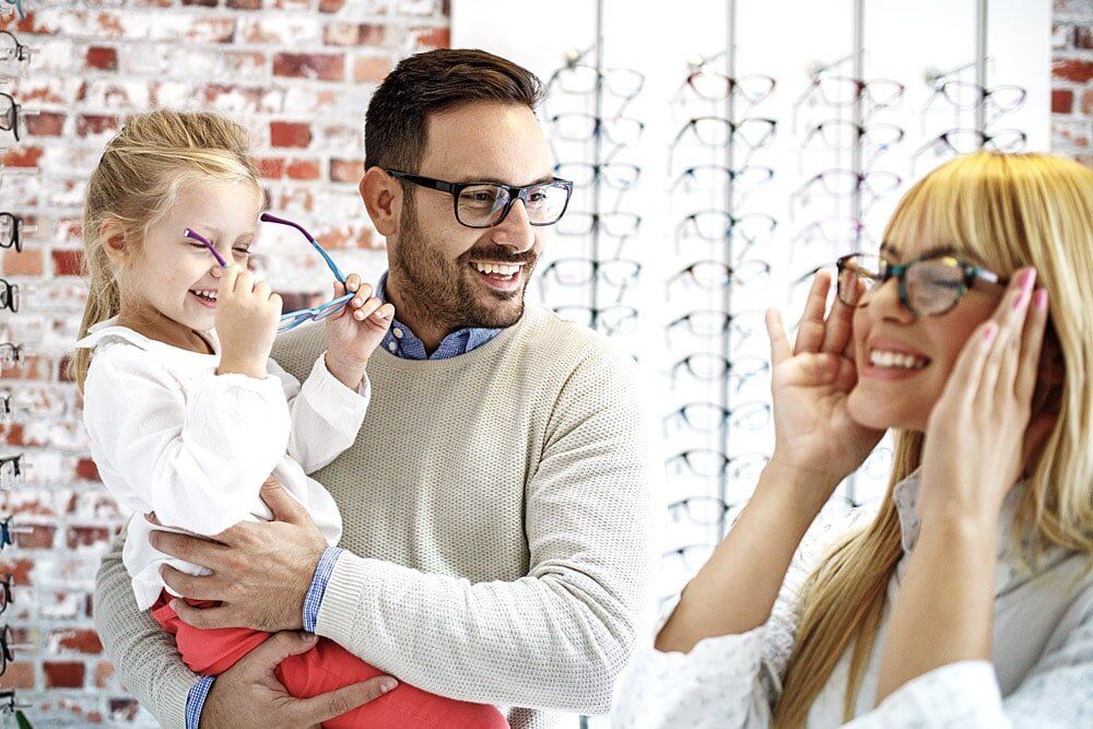 Family Trying On Glasses - Clear Optometry In Bargara, QLD