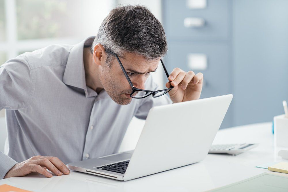 Man Staring At The Laptop Screen - Clear Optometry In Bargara, QLD Man Staring At The Laptop Screen - Clear Optometry In Bargara, QLD