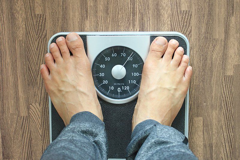 Individual weighing himself