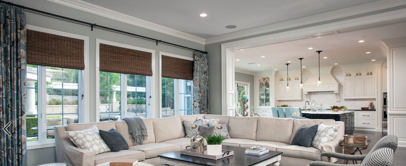 A living room with a large sectional couch and a coffee table.