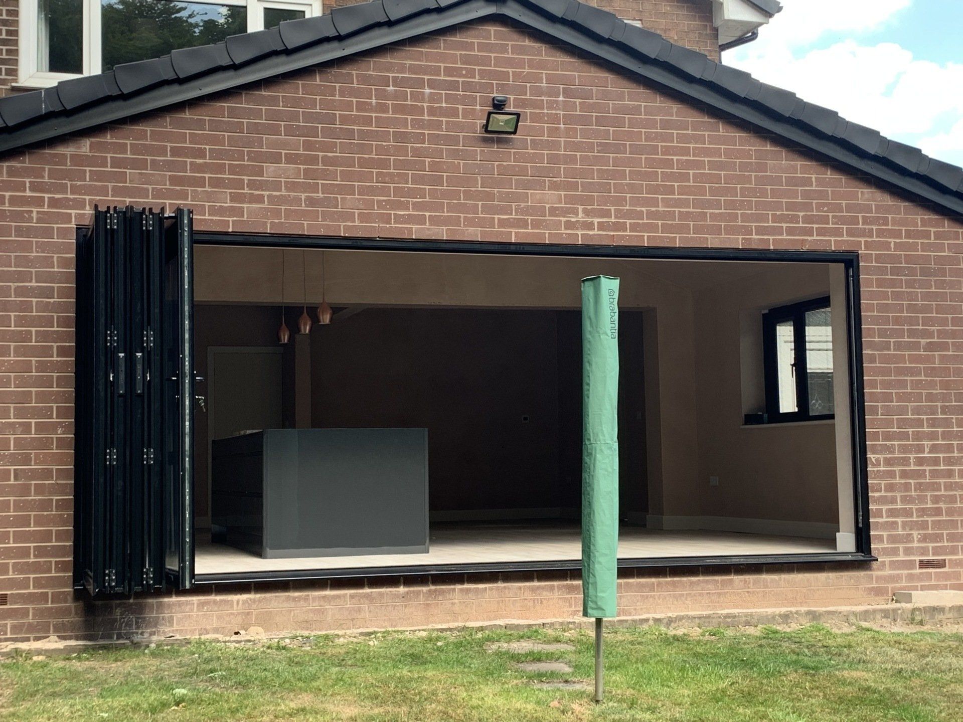 aluminium bifold doors installed in Bamford rochdale with blinds inside glass