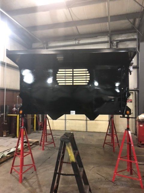 A black object is sitting on a ladder in a garage